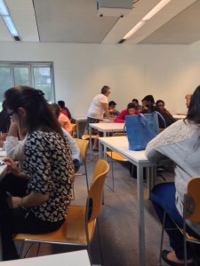 Students engaged in class activity at HEC Belgium