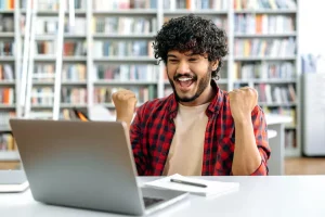 Happy student in front of laptop